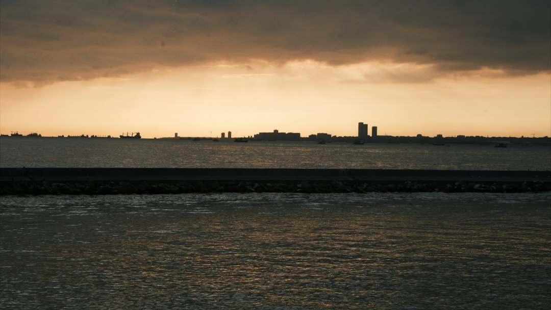 Skyline of a coastal city at dusk